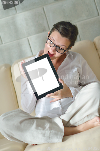 Image of woman using tablet pc at home