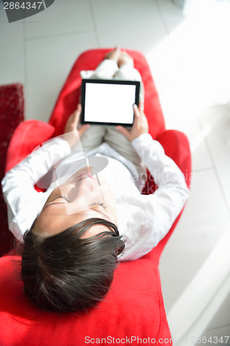 Image of young woman watching tv at home