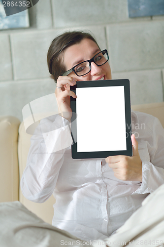 Image of woman using tablet pc at home