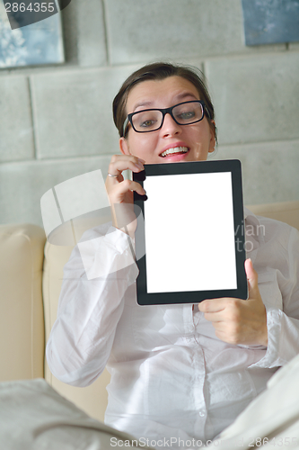 Image of woman using tablet pc at home
