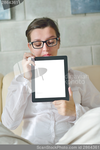 Image of woman using tablet pc at home