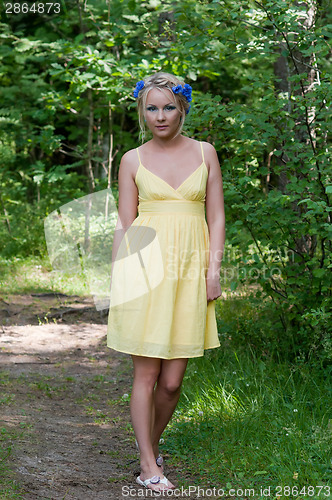 Image of Young beautiful lady in yellow dress in