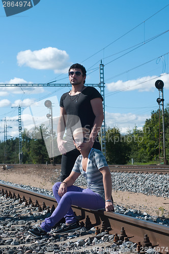 Image of Two young attractive guy on rails