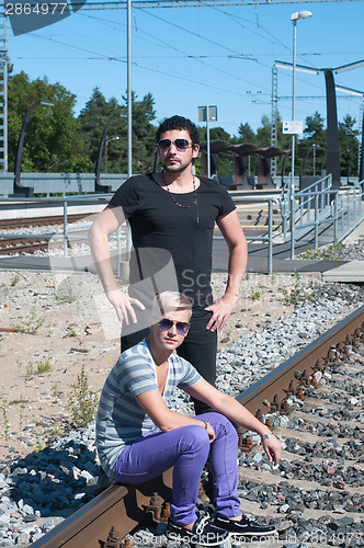 Image of Two attractive young guys on rails