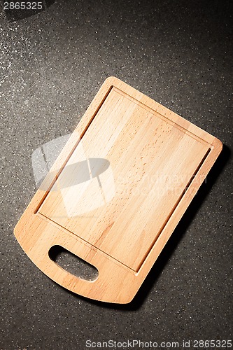 Image of cutting board on a dark background