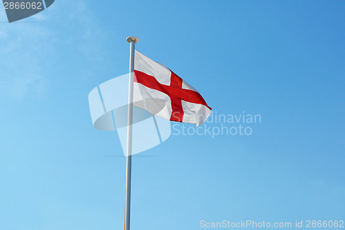 Image of The English flag flies against a blue sky