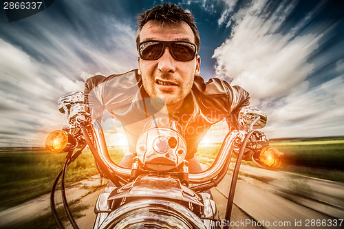 Image of Biker racing on the road