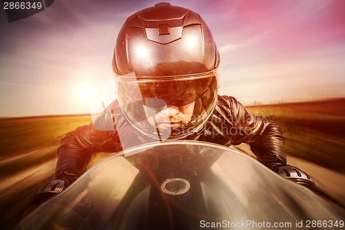 Image of Biker racing on the road