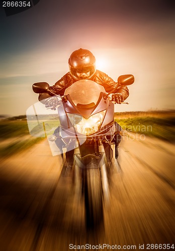 Image of Biker racing on the road