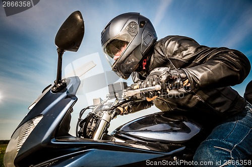 Image of Biker racing on the road