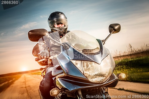 Image of Biker racing on the road