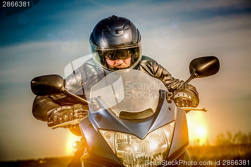 Image of Biker racing on the road