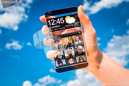 Image of Smartphone with transparent screen in human hands.