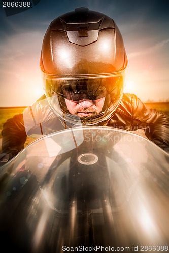 Image of Biker racing on the road