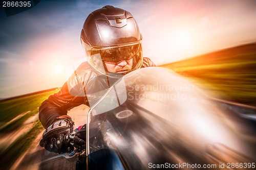 Image of Biker racing on the road