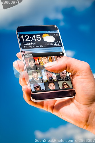 Image of Smartphone with transparent screen in human hands.