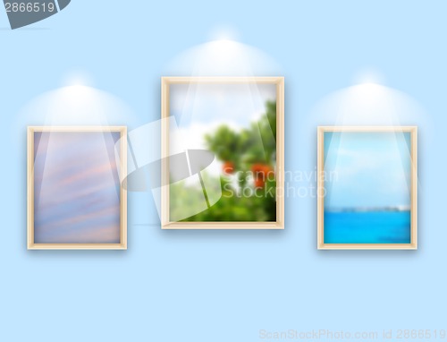 Image of Three frames with photos hanging on wall