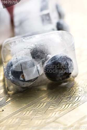 Image of Fresh berry fruits frozen in ice cubes