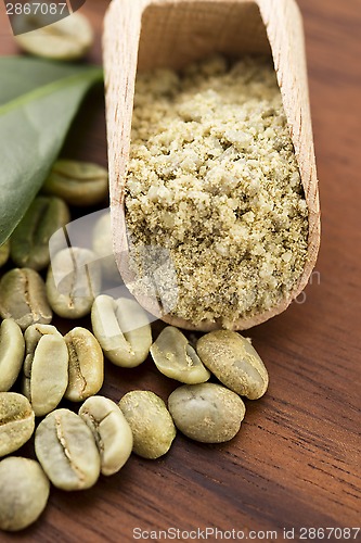 Image of Green coffee beans with leaf