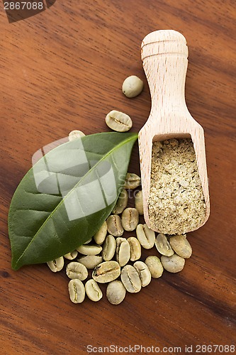 Image of Green coffee beans with leaf