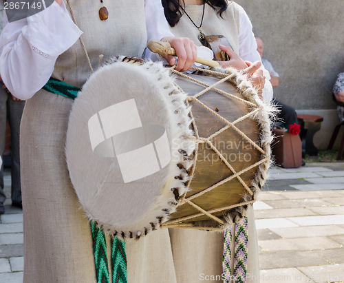 Image of woman hand with retro vintage fur decorated drum