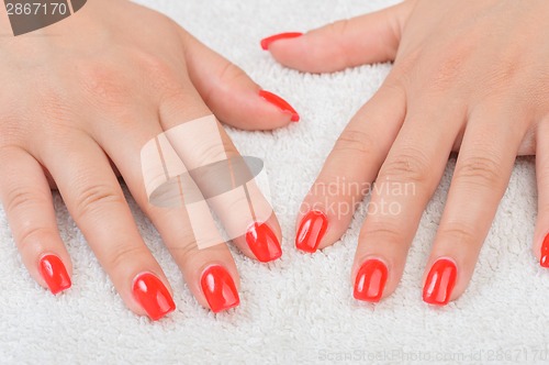 Image of female fingers with red enamel