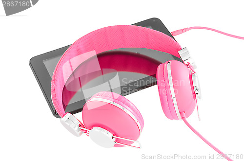 Image of Vibrant pink female headphones and black tablet pc