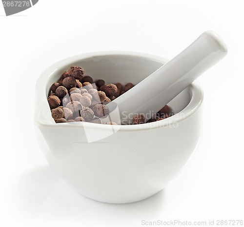 Image of Aromatic black peppers in a mortar and pestle