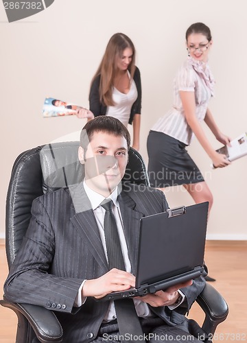 Image of Businessman with laptop works in office