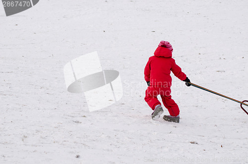 Image of child with red waterproof overall outdoor winter 