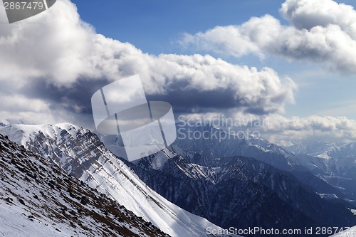 Image of Winter mountains in evening and cloudy sky