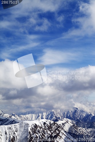 Image of Winter snowy mountains and cloudy sky