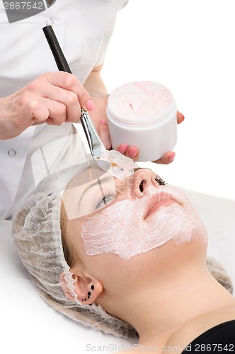 Image of facial peeling mask applying