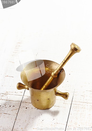 Image of mortar and pestle on white wooden table