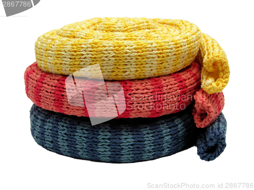 Image of Three striped reeled up knitting scarfs on white
