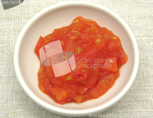 Image of Tomato dip in an little bowl of chinaware on beige
