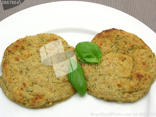 Image of Round flat potato dough cakes with basil 