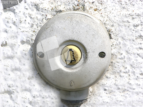 Image of Round and dirty bell at the outside of a house