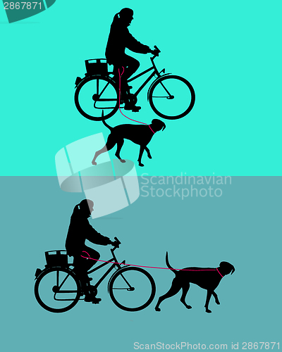 Image of Women on bicycle with dogs on leash