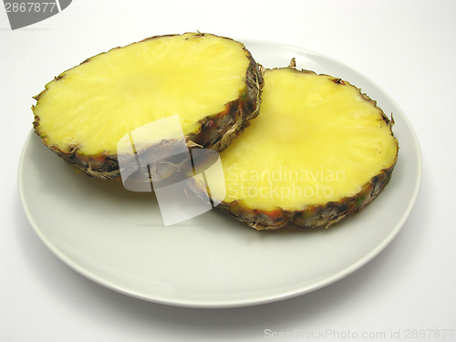 Image of Two slices of pineapple on a white plate