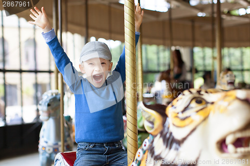 Image of boy at carousel