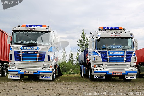 Image of Two Colorful Scania Tipper Trucks in a Show