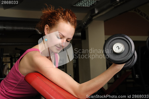 Image of Girl with dumbbell in the gym