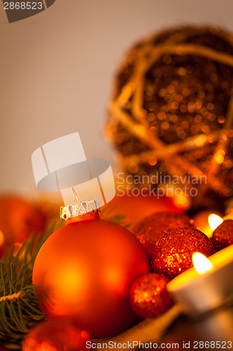Image of Warm gold and red Christmas candlelight background