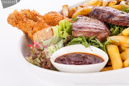 Image of Platter of mixed meats, salad and French fries