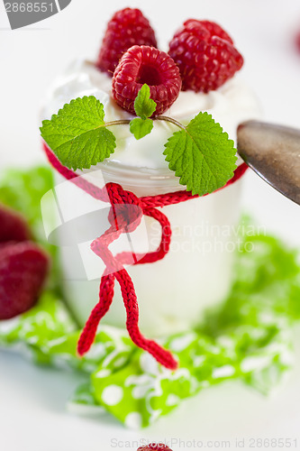 Image of Raspberries and yoghurt or clotted cream