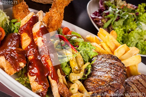 Image of Platter of mixed meats, salad and French fries