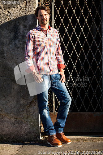 Image of Male model leaning against wall