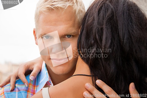 Image of Romantic handsome man hugging his girlfriend