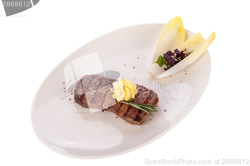 Image of Grilled beef steak topped with butter and rosemary